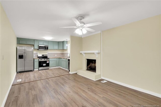 1772 Inverness Dr, Fayetteville, NC 28304 - kitchen with light wood-style flooring, appliances with stainless steel finishes, green cabinetry, baseboards, and ceiling fan