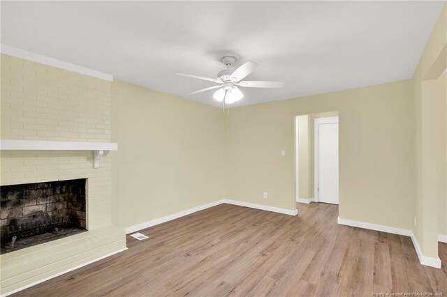 1772 Inverness Dr, Fayetteville, NC 28304 - unfurnished living room with visible vents, wood finished floors, a fireplace, baseboards, and ceiling fan