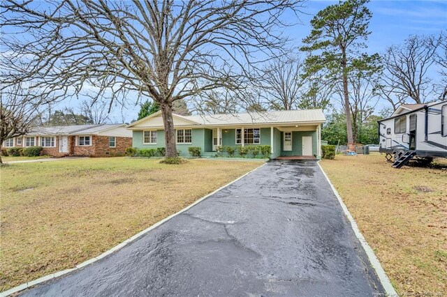 1772 Inverness Dr, Fayetteville, NC 28304 - view of front of home with aphalt driveway, a carport, a front lawn, and metal roof