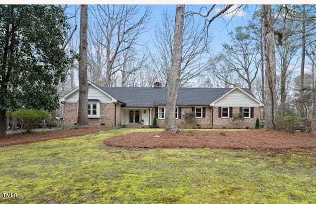 single story home with crawl space, a chimney, a front yard, and brick siding