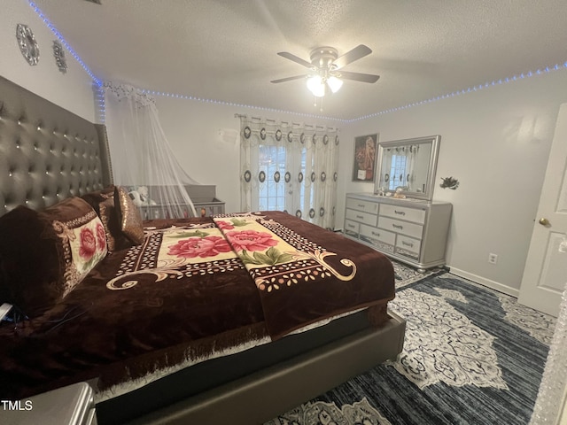 bedroom featuring ceiling fan, a textured ceiling, and baseboards