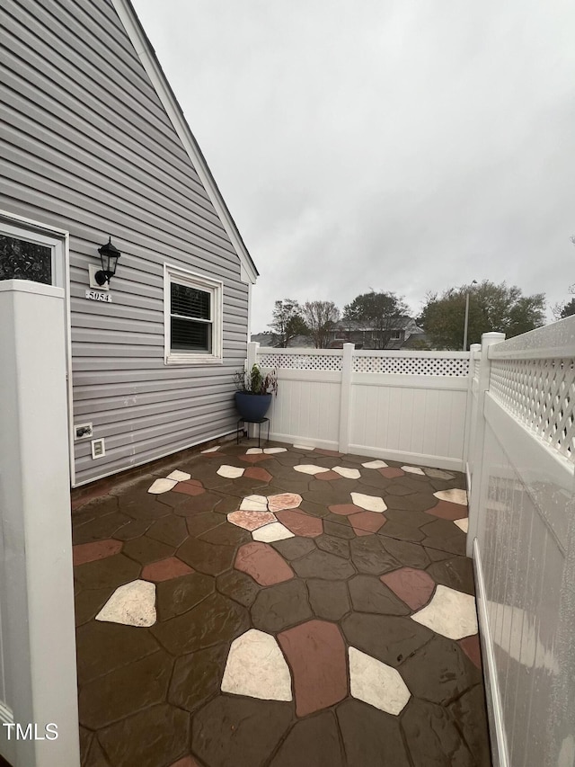 view of patio featuring fence