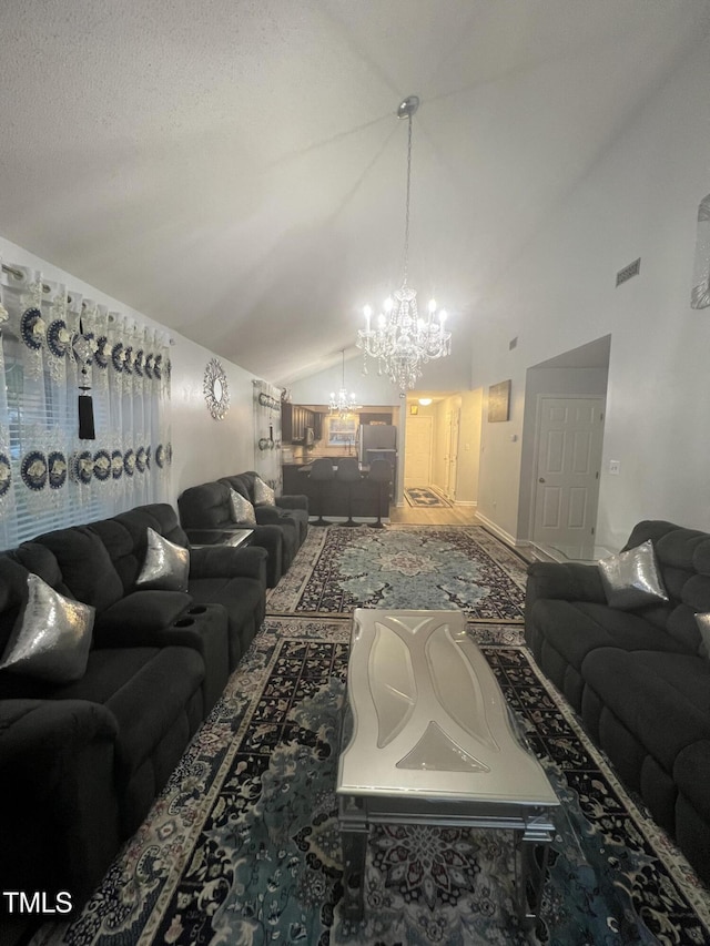 living area with an inviting chandelier, high vaulted ceiling, visible vents, and a textured ceiling
