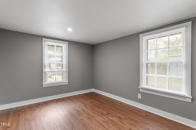 empty room featuring baseboards and wood finished floors