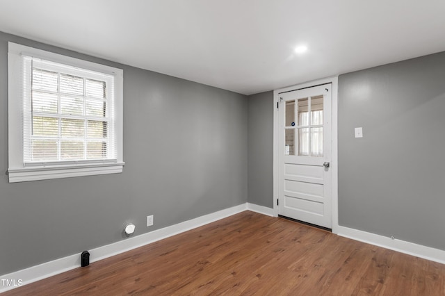 interior space featuring baseboards and wood finished floors