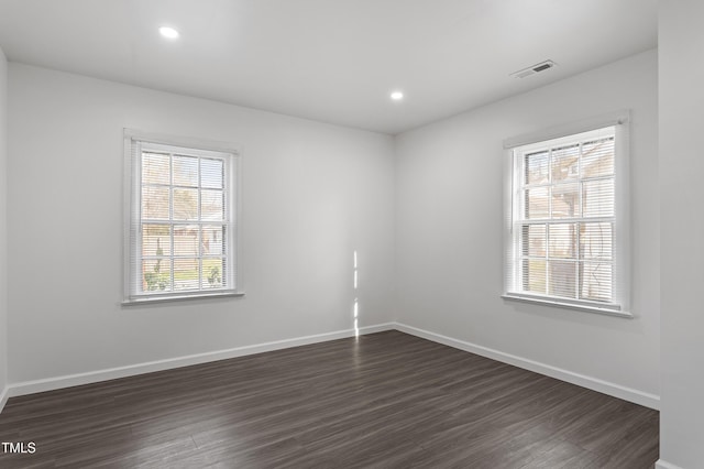 unfurnished room featuring baseboards, visible vents, recessed lighting, and dark wood-type flooring