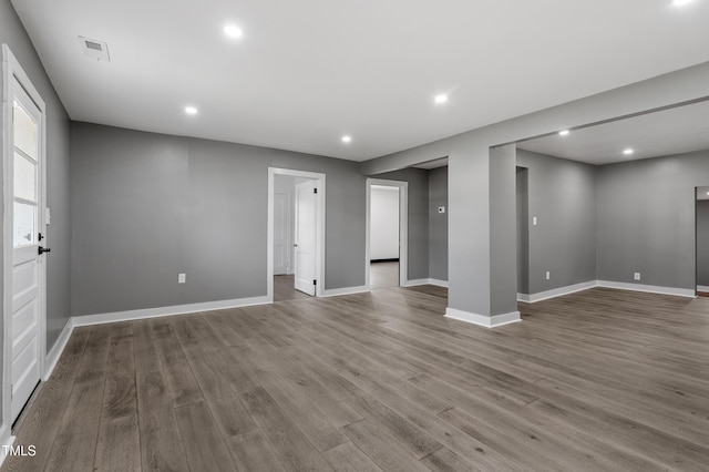 interior space featuring baseboards, wood finished floors, and recessed lighting