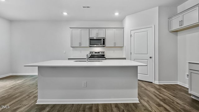 1010 Ocean Ct, Carthage, NC 28327 - kitchen featuring stainless steel appliances, dark wood-style flooring, gray cabinets, light countertops, and recessed lighting