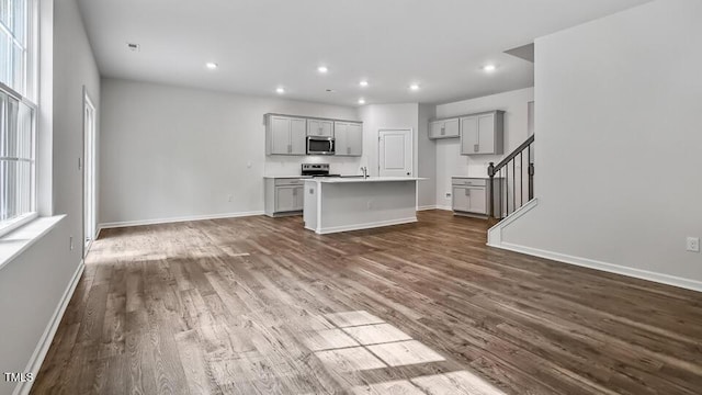 1010 Ocean Ct, Carthage, NC 28327 - kitchen with appliances with stainless steel finishes, gray cabinetry, dark wood-style floors, a center island with sink, and recessed lighting