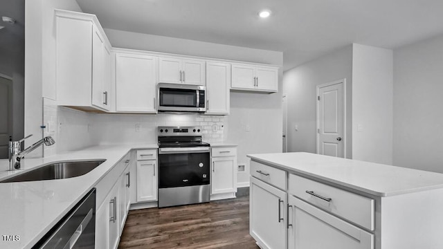 1014 Ocean Ct, Carthage, NC 28327 - kitchen featuring stainless steel appliances, dark wood-type flooring, decorative backsplash, white cabinets, and recessed lighting