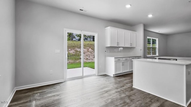 1014 Ocean Ct, Carthage, NC 28327 - kitchen featuring light countertops, white cabinets, dark wood finished floors, recessed lighting, and a center island