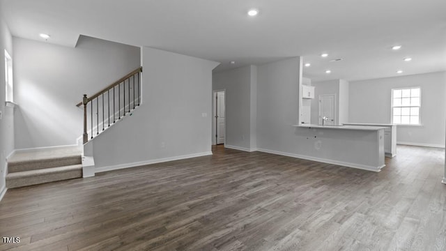1014 Ocean Ct, Carthage, NC 28327 - unfurnished living room featuring stairway, dark wood-type flooring, and recessed lighting