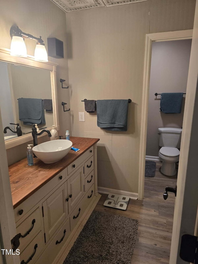 225 Sebastian Way, Rocky Mount, NC 27804 - bathroom featuring toilet, baseboards, wood finished floors, and vanity