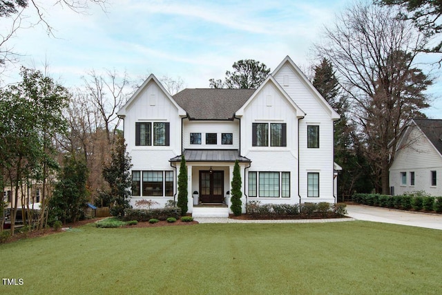 modern inspired farmhouse with a front lawn, french doors, a standing seam roof, board and batten siding, and metal roof