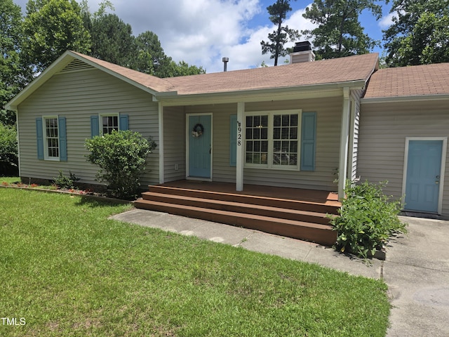 928 Magnolia Ridge Way, Fuquay Varina, NC 27526 - ranch-style home with covered porch, a chimney, a front yard, and roof with shingles