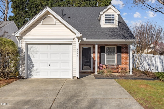 cape cod home featuring concrete driveway, fence, an attached garage, brick siding, and a porch