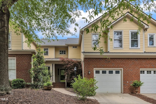 11035 Southwalk Ln, Raleigh, NC 27614 - view of front facade with an attached garage, driveway, brick siding, and roof with shingles