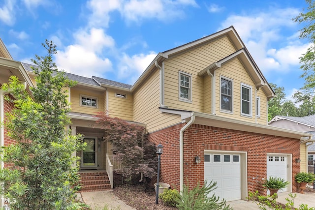11035 Southwalk Ln, Raleigh, NC 27614 - view of front facade with an attached garage, brick siding, and concrete driveway