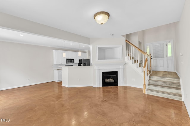 11035 Southwalk Ln, Raleigh, NC 27614 - unfurnished living room with concrete floors, stairs, baseboards, a fireplace, and recessed lighting