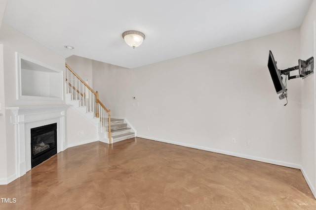11035 Southwalk Ln, Raleigh, NC 27614 - unfurnished living room featuring finished concrete flooring, stairway, baseboards, and a glass covered fireplace