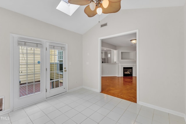 11035 Southwalk Ln, Raleigh, NC 27614 - empty room with ceiling fan, lofted ceiling, a skylight, a fireplace, and baseboards