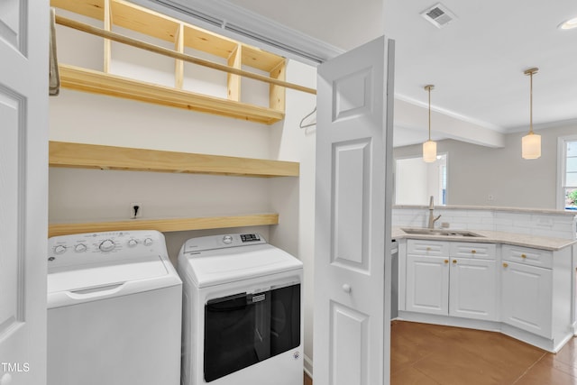 11035 Southwalk Ln, Raleigh, NC 27614 - washroom with ornamental molding, washer and dryer, and light tile patterned floors
