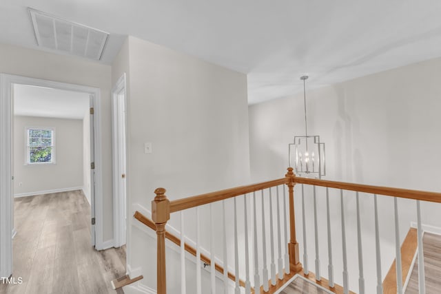 11035 Southwalk Ln, Raleigh, NC 27614 - corridor featuring an upstairs landing, light wood-style floors, a chandelier, and baseboards