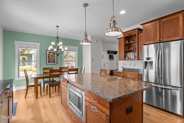kitchen with brown cabinetry, appliances with stainless steel finishes, open shelves, light wood-type flooring, and a chandelier