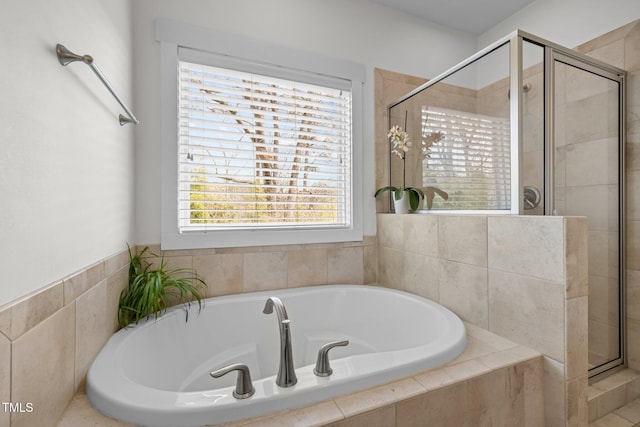full bathroom featuring a shower stall and a garden tub