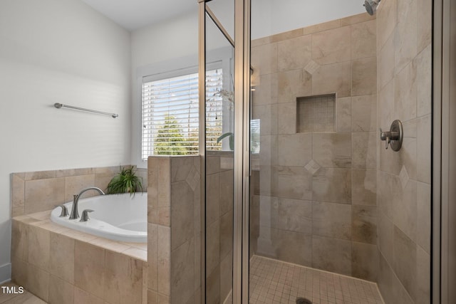 bathroom featuring a shower stall and a garden tub