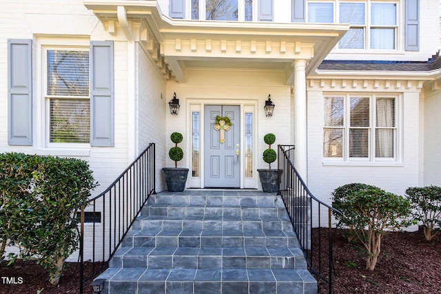 property entrance featuring brick siding