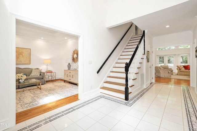 stairway featuring tile patterned flooring, recessed lighting, crown molding, and baseboards