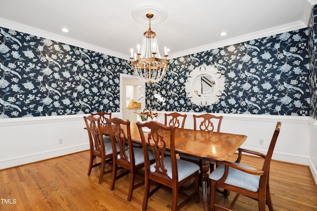 dining space with baseboards, wallpapered walls, light wood-style flooring, ornamental molding, and a chandelier