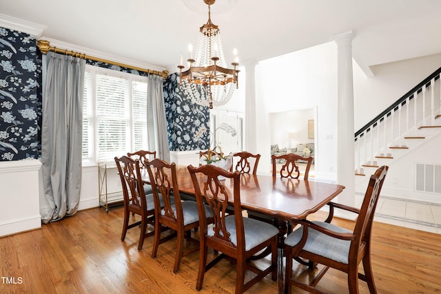 dining space with visible vents, light wood-style floors, a chandelier, and stairway
