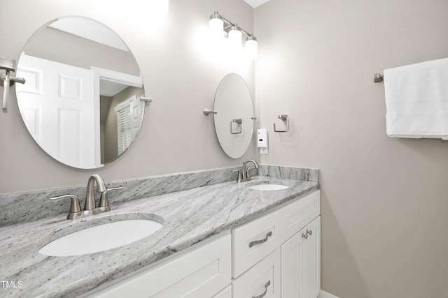bathroom featuring double vanity and a sink