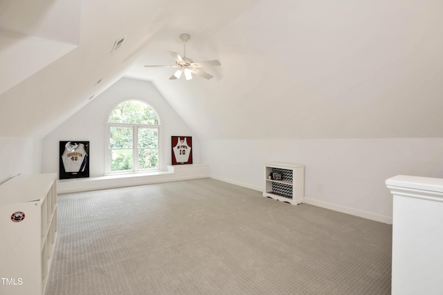 bonus room featuring visible vents, a ceiling fan, baseboards, lofted ceiling, and light colored carpet