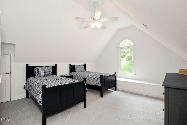 bedroom with lofted ceiling, light colored carpet, baseboards, and ceiling fan