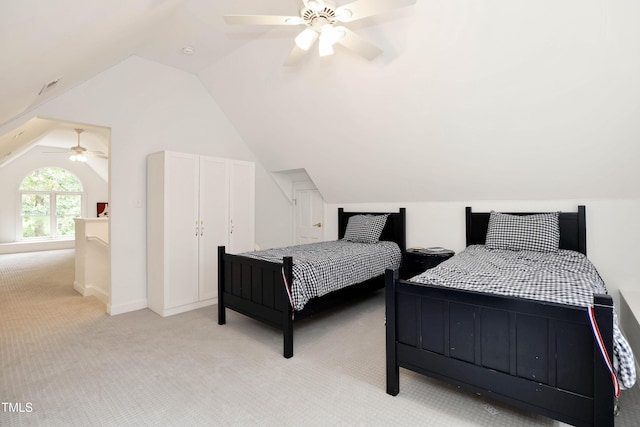 bedroom with light carpet, lofted ceiling, and a ceiling fan