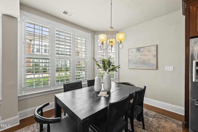 10529 Sablewood Dr Unit 111, Raleigh, NC 27617 - dining area with baseboards, dark wood-style floors, and a chandelier