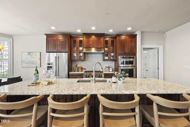 10529 Sablewood Dr Unit 111, Raleigh, NC 27617 - kitchen with appliances with stainless steel finishes, a sink, tasteful backsplash, glass insert cabinets, and recessed lighting