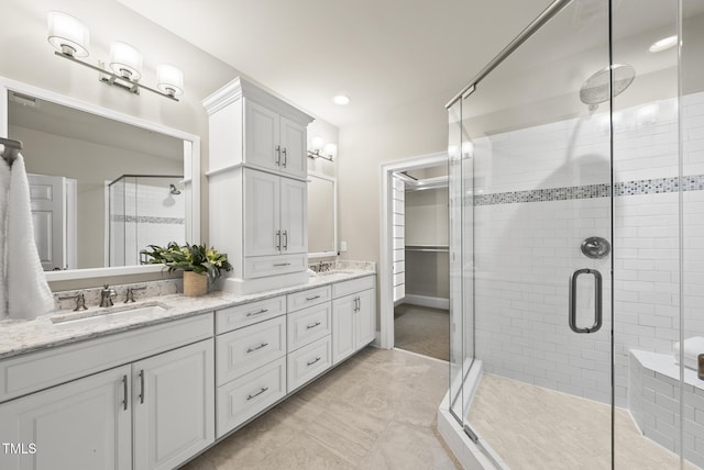 10529 Sablewood Dr Unit 111, Raleigh, NC 27617 - bathroom featuring a shower stall, double vanity, and a closet