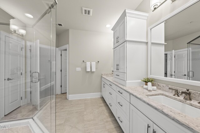 10529 Sablewood Dr Unit 111, Raleigh, NC 27617 - full bath featuring double vanity, a shower stall, baseboards, marble look tiles, and recessed lighting