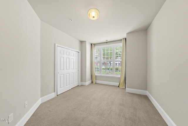 10529 Sablewood Dr Unit 111, Raleigh, NC 27617 - unfurnished bedroom with carpet flooring, baseboards, and a closet