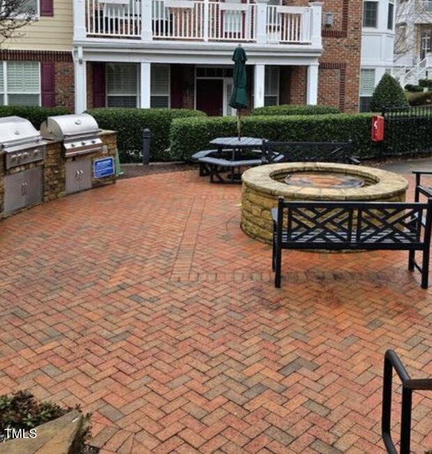 10529 Sablewood Dr Unit 111, Raleigh, NC 27617 - view of community with an outdoor kitchen and a patio area
