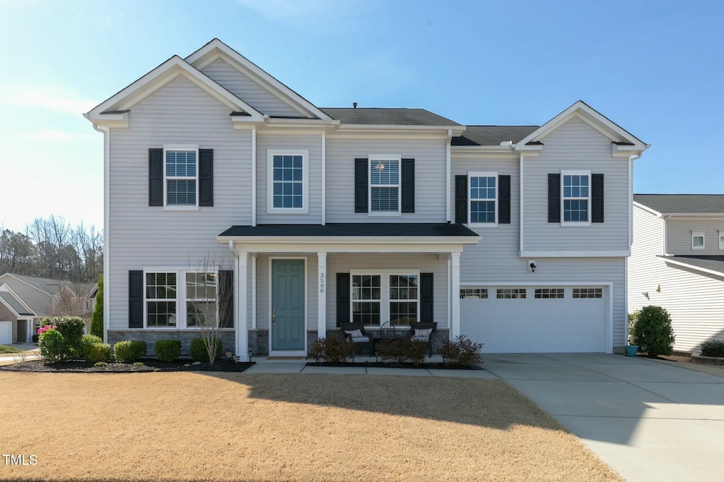 3508 Longleaf Estates Dr, Raleigh, NC 27616 - view of front of property featuring a garage, stone siding, covered porch, and driveway