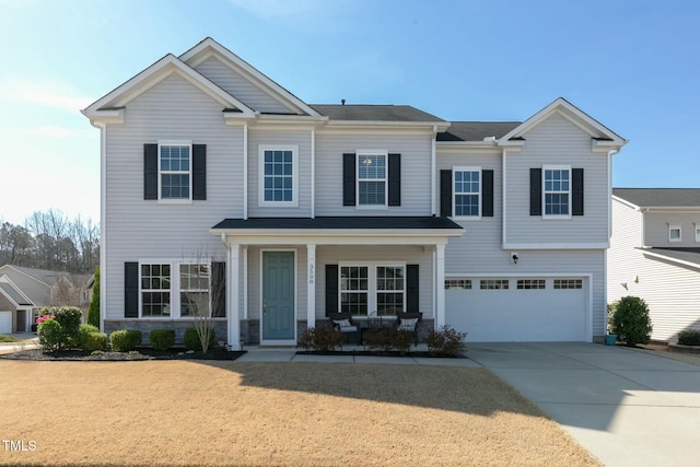 3508 Longleaf Estates Dr, Raleigh, NC 27616 - view of front of property featuring a garage, stone siding, covered porch, and driveway