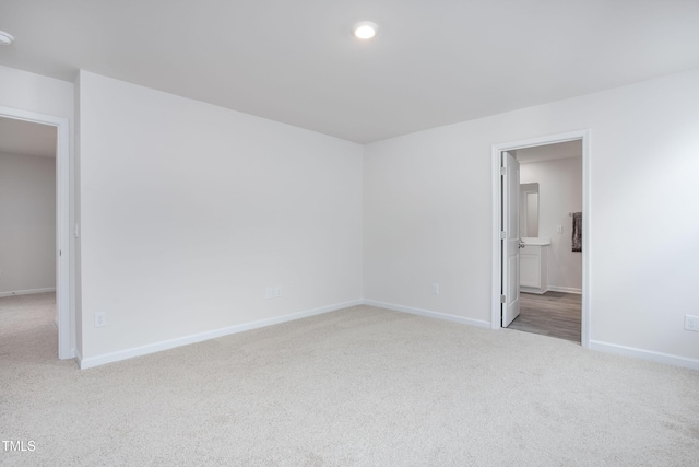 carpeted empty room featuring baseboards and recessed lighting