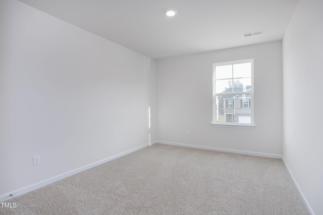 unfurnished room with light carpet, baseboards, visible vents, and recessed lighting