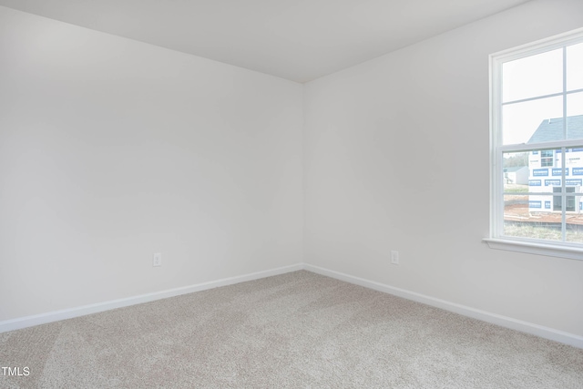 empty room with baseboards and carpet floors