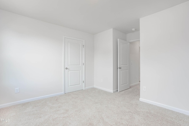 carpeted spare room with baseboards